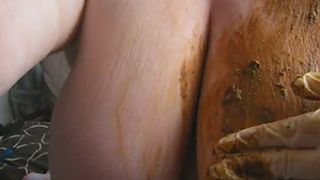 Smearing crap on her big boobs