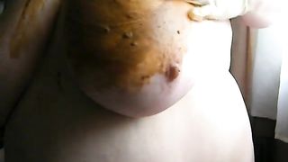 Smearing crap on her big boobs