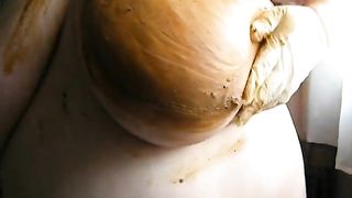 Smearing crap on her big boobs