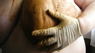 Smearing crap on her big boobs