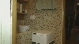 Girl pooping in a biotoilet