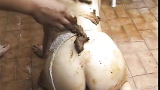 Smearing shit on her body