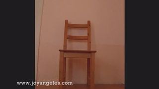 Naked on a wooden chair