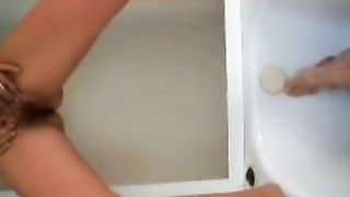 Sexy babe peeing on her own face