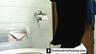 Curvy blonde shitting in toilet