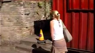 Blonde teen peeing behind a building