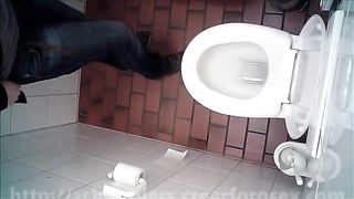 Blonde girl using a public bathroom