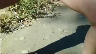 Tanned milf pooping outdoor