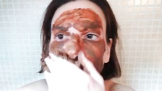 Smearing brown shit on her face and tits