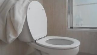 Slim girl pooping over toilet