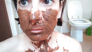 Rubbing shit on her face