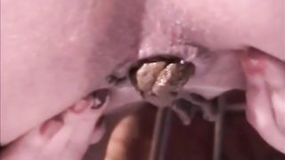 Close up of a brunette babe shitting