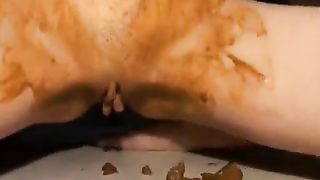 Horny brunette milf smears shit on entire body