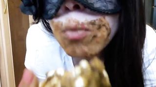 Masked brunette smears shit on her face