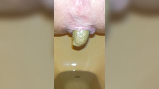 Close up of sweet babe shitting slowly