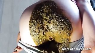 Dark haired babe smears poop hard