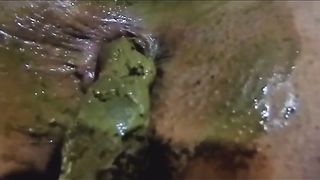Black babe pooping in close up