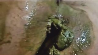 Black babe pooping in close up