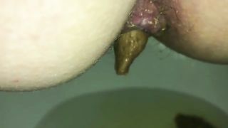 Hairy milf pushing big turd