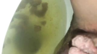Hairy babe shitting over toilet