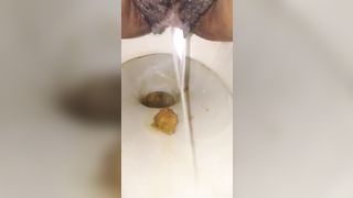 Hairy ebony shits in toilet