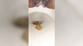 Hairy ebony shits in toilet