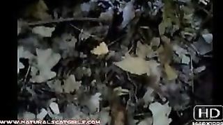 Busty brunette shitting in forest