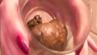 Blonde girl shitting in a glass