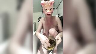 Pig masked busty swallows her own shit
