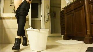 Lady in high heels fills bucket with diarrhea