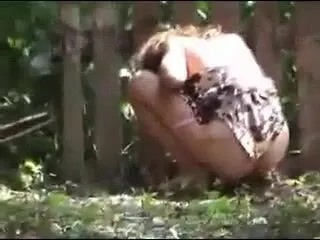 Amateur lady caught pooping in the woods
