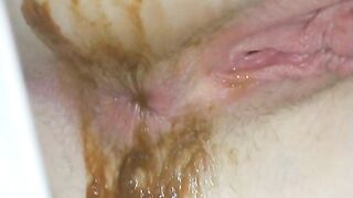 Sexy and kinky brunette lady pooping in the tub