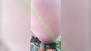 Closeup of sexy lady pooping in the forest