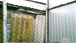 Woman shit behind the fence