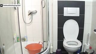 Cute brunette tattooed girl poops at home