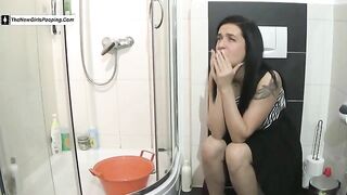 Cute brunette tattooed girl poops at home