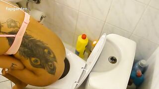 Brunette tattooed babe poops in the toilet