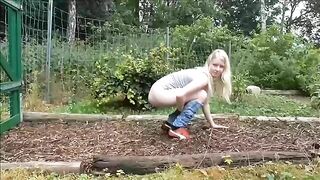 Sweet blonde girl pooping in the farm