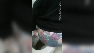 Horny tattooed ass girl poops in the toilet