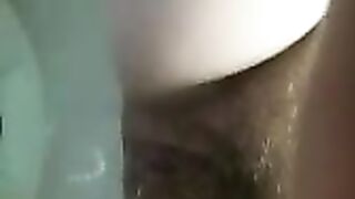 Girl shits on a bathroom toilet