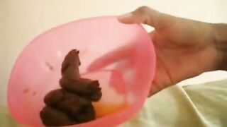 Messy poop in her pink plastic container