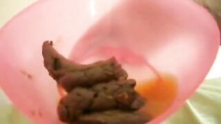 Messy poop in her pink plastic container