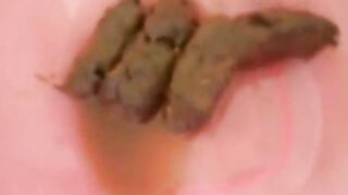 Messy poop in her pink plastic container