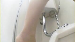 A woman takes a giant shit into a toilet