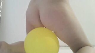 Girl squats and takes a huge shit on a yellow ball