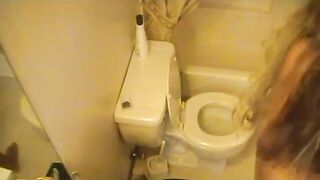 Tanned hot blonde girl poops in the toilet