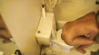 Tanned hot blonde girl poops in the toilet