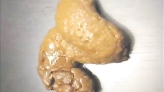 Girl spread legs and shitting on a table