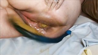 Yellow poop on a black dildo