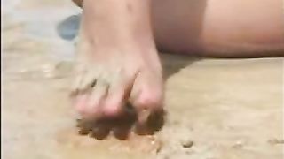 Indian girl shitting on the sand